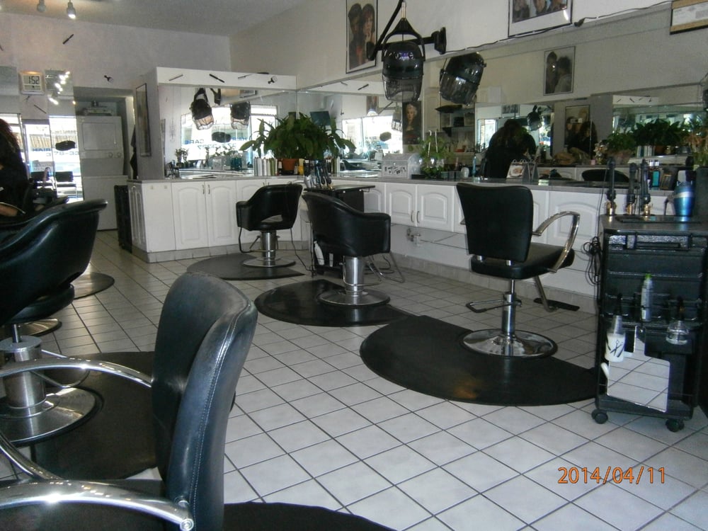 empty hair salon with black styling chairs